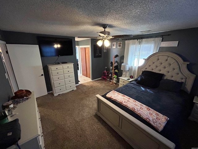 carpeted bedroom featuring a textured ceiling and ceiling fan