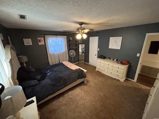 bedroom featuring a textured ceiling, dark carpet, and ceiling fan