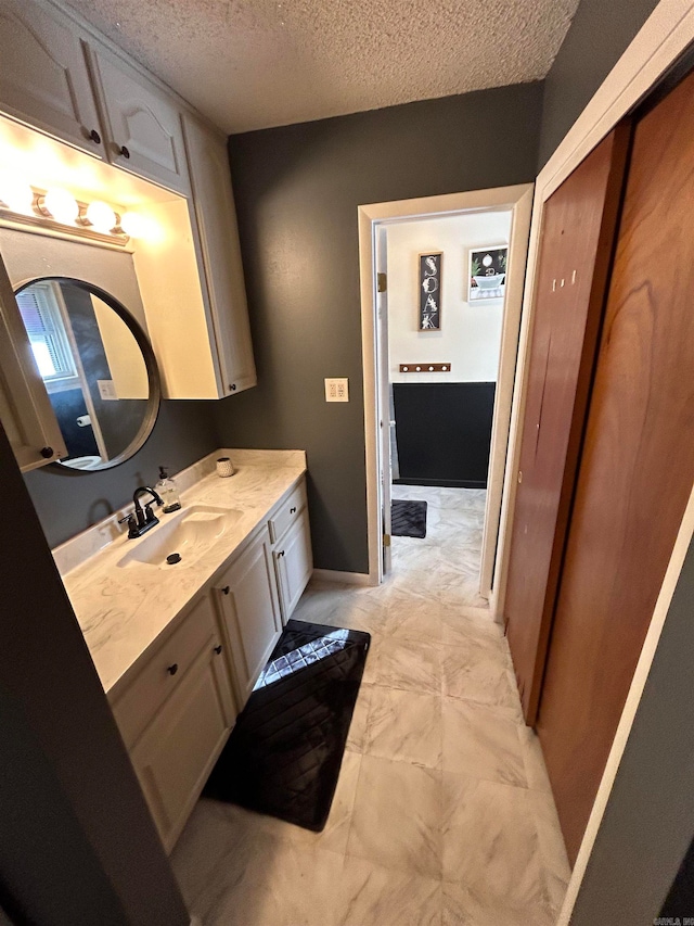 bathroom featuring vanity and a textured ceiling