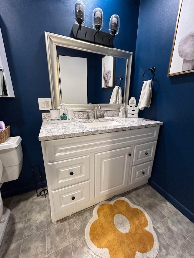 bathroom featuring vanity, toilet, and tile patterned floors