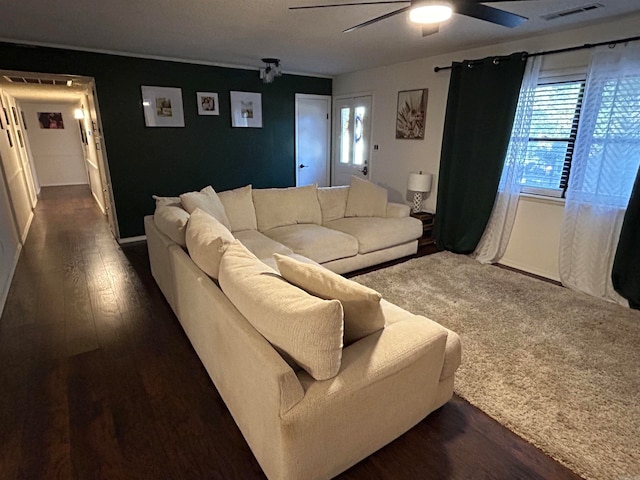 living room featuring dark hardwood / wood-style floors and ceiling fan