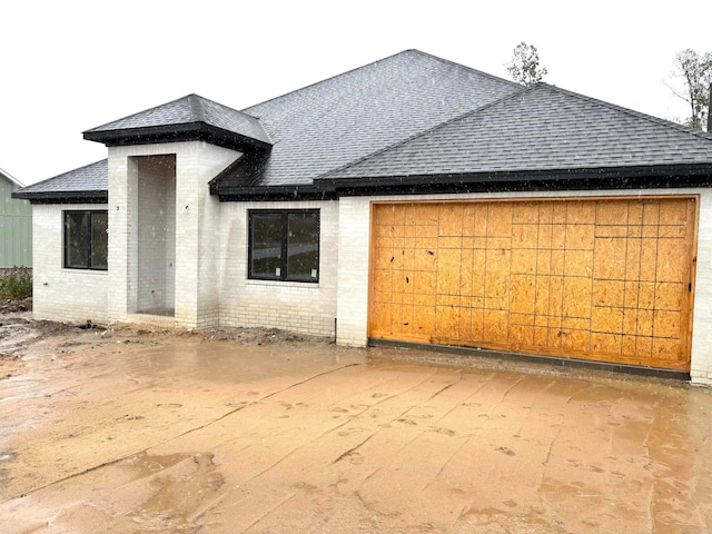 rear view of house featuring a garage