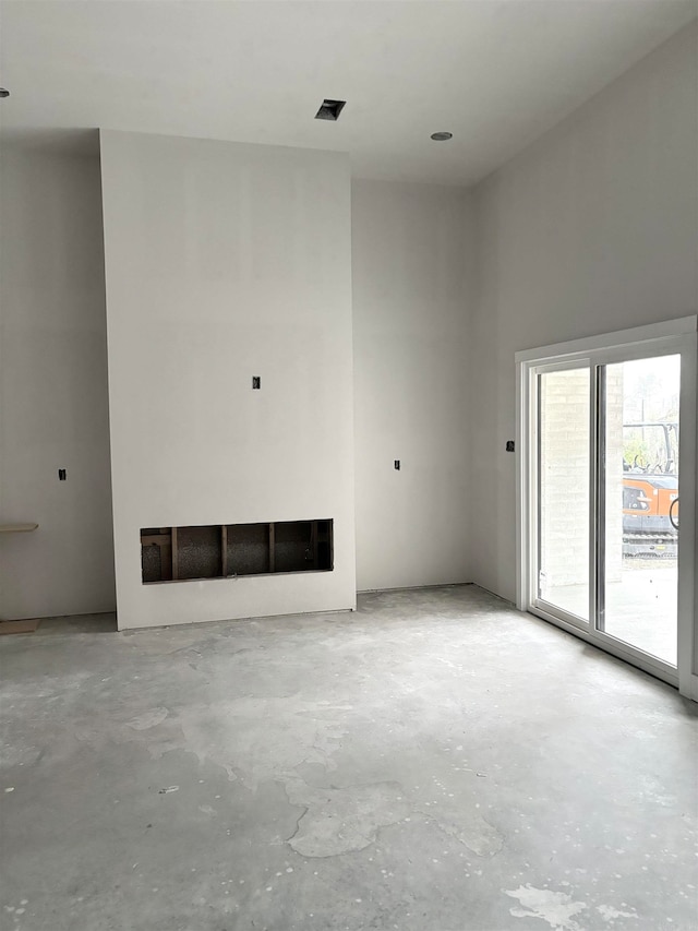 unfurnished living room with concrete flooring