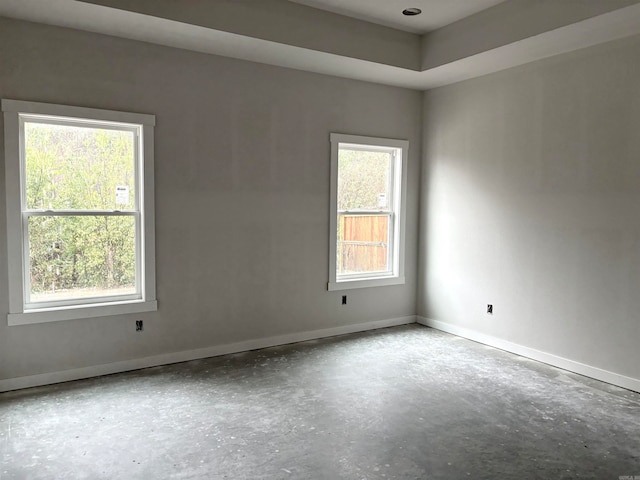 empty room with plenty of natural light and concrete floors