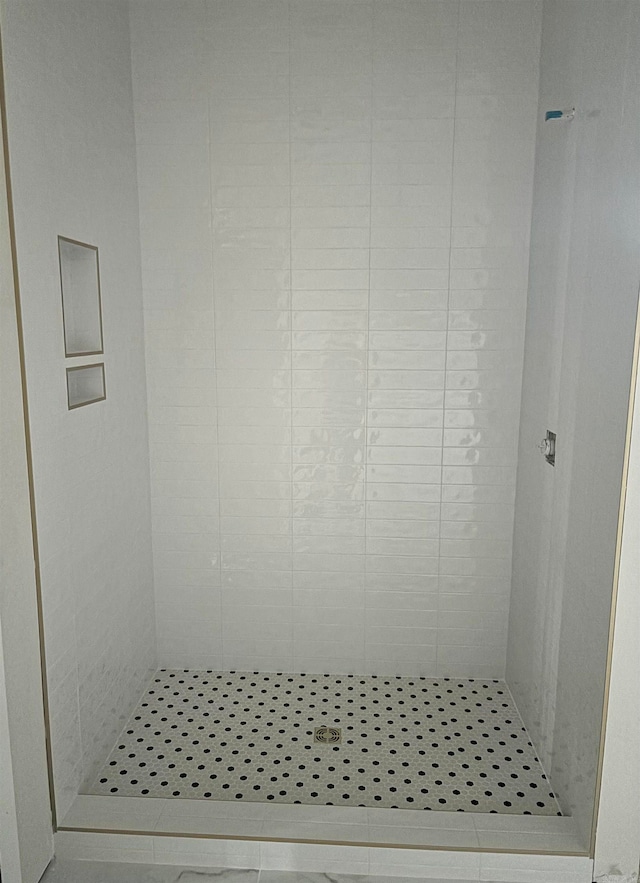 bathroom with tile patterned floors and walk in shower