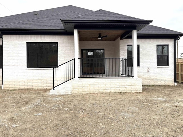 rear view of property featuring ceiling fan and covered porch