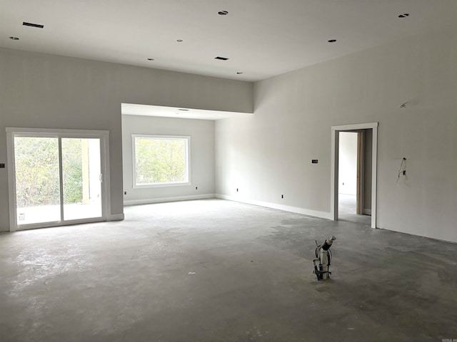 unfurnished room with concrete floors