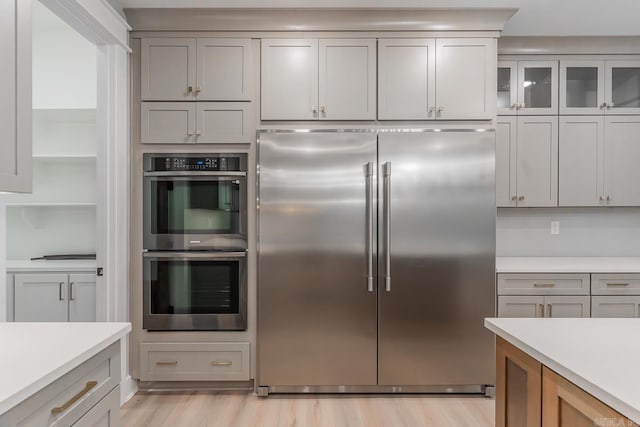 kitchen with light wood-type flooring and appliances with stainless steel finishes