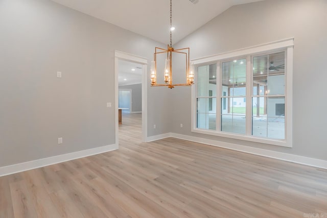 unfurnished dining area with light hardwood / wood-style floors, vaulted ceiling, and a notable chandelier