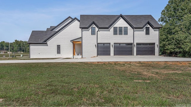 view of front of property featuring a garage and a front yard