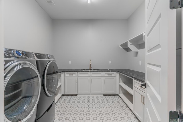 clothes washing area featuring sink and independent washer and dryer