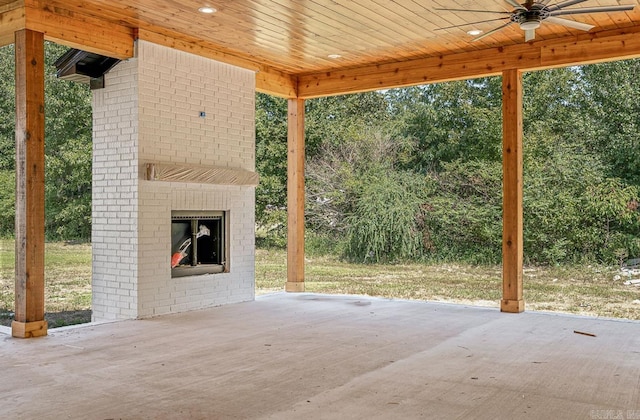 view of patio featuring exterior fireplace and ceiling fan