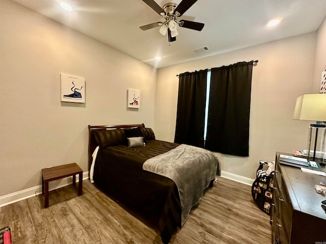 bedroom featuring hardwood / wood-style flooring and ceiling fan