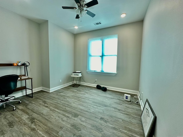 interior space featuring wood-type flooring and ceiling fan