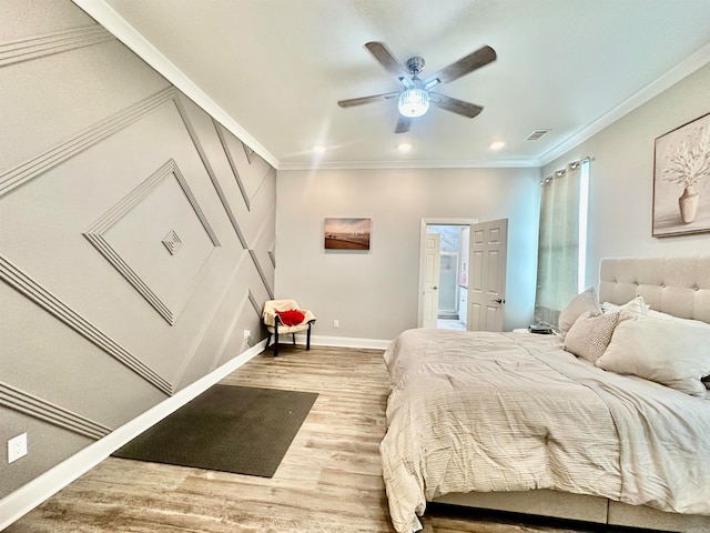 bedroom featuring light hardwood / wood-style floors, ceiling fan, and ornamental molding