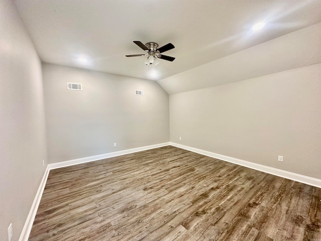 spare room featuring hardwood / wood-style flooring, ceiling fan, and vaulted ceiling