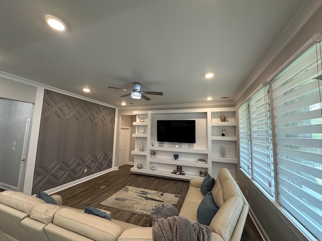 living room featuring ceiling fan, a wealth of natural light, dark hardwood / wood-style floors, and crown molding