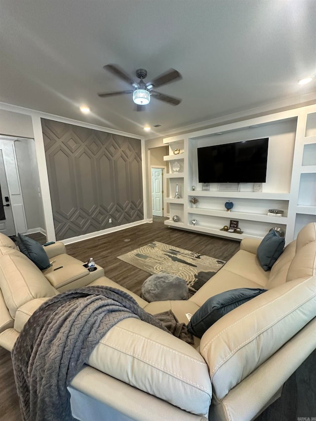 living room with ceiling fan, wood-type flooring, crown molding, and built in shelves