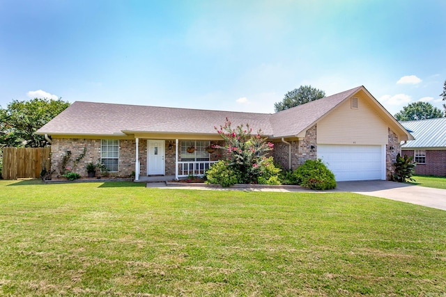 single story home featuring a porch, a front yard, and a garage