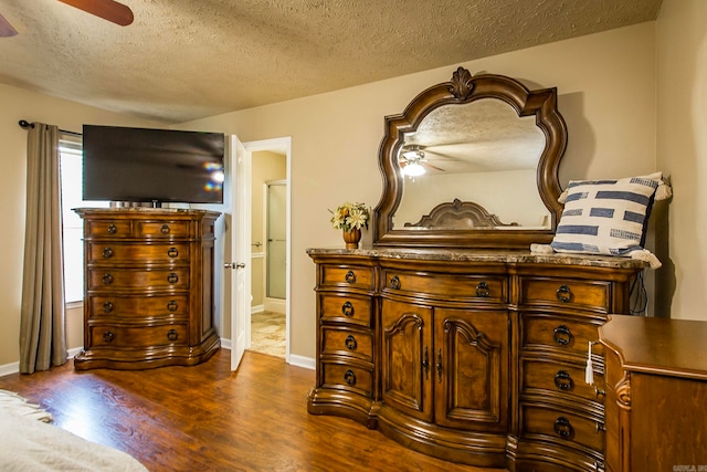 interior space featuring a textured ceiling, dark hardwood / wood-style floors, and ceiling fan