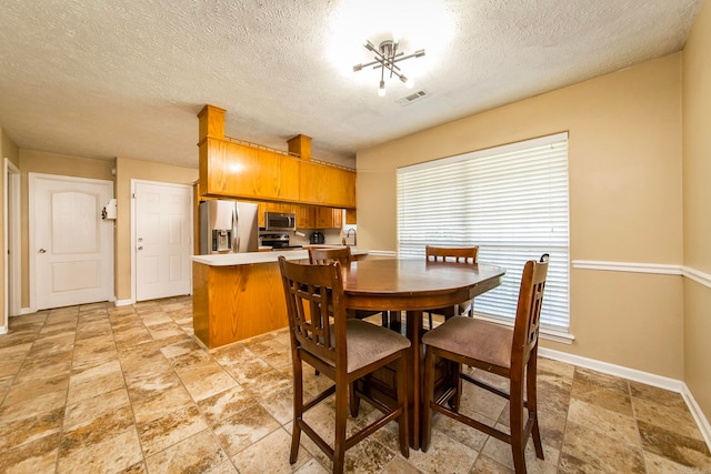 dining area featuring a textured ceiling