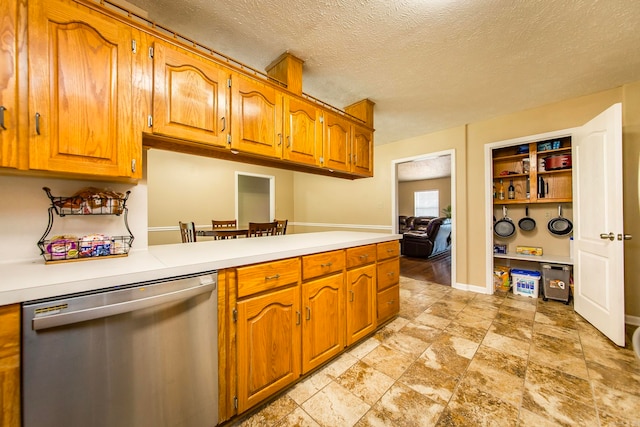 kitchen with dishwasher, kitchen peninsula, and a textured ceiling