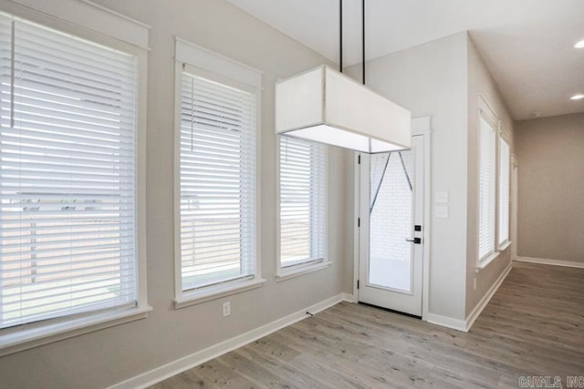 doorway to outside with light wood-type flooring