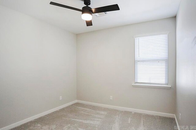 carpeted spare room featuring ceiling fan