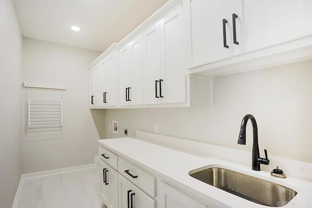 washroom featuring cabinets, hookup for an electric dryer, sink, and washer hookup