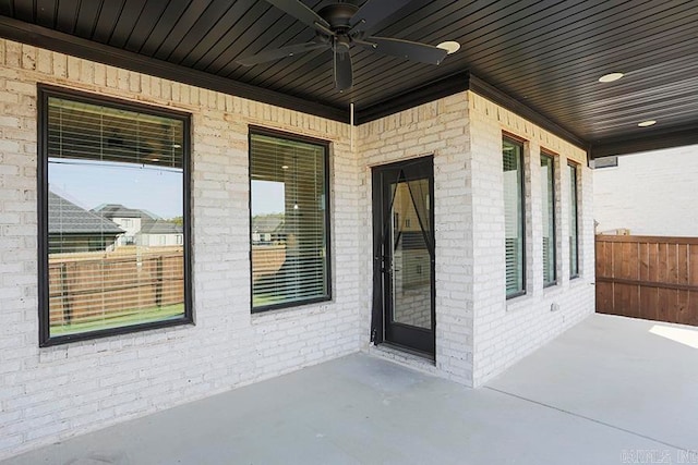 entrance to property featuring a patio area and ceiling fan