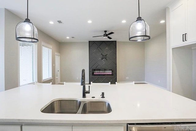 kitchen with white cabinetry, sink, pendant lighting, and dishwasher