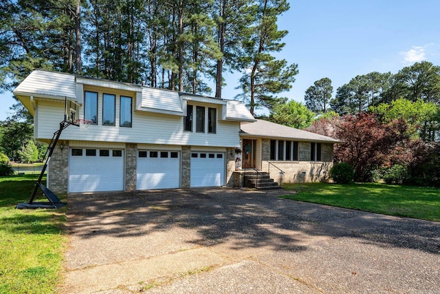 split level home featuring a front yard and a garage