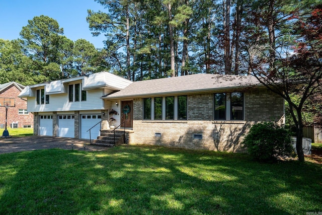 tri-level home featuring a front lawn and a garage