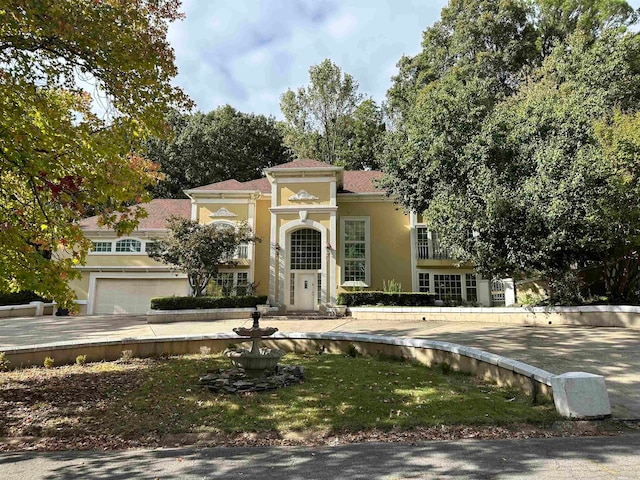 mediterranean / spanish home featuring a garage