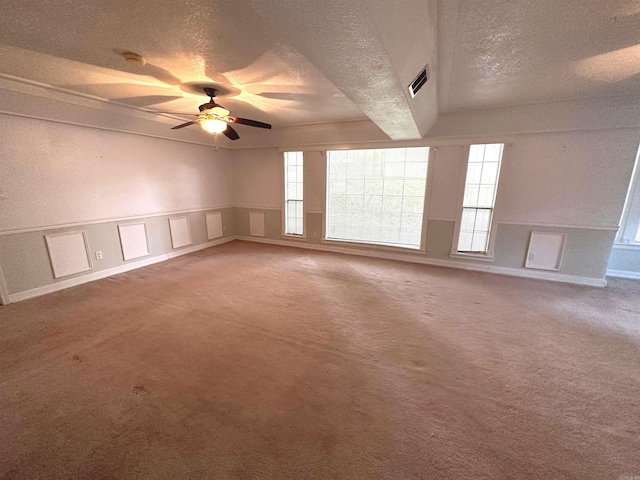 carpeted empty room with a textured ceiling and ceiling fan