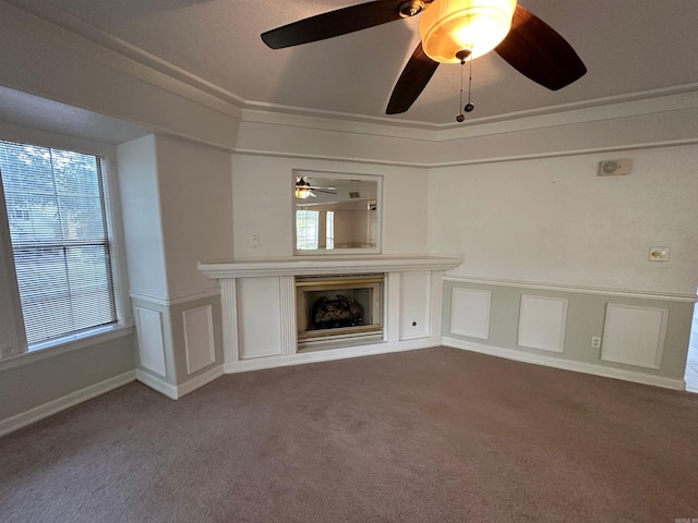 unfurnished living room featuring crown molding, carpet flooring, a healthy amount of sunlight, and ceiling fan