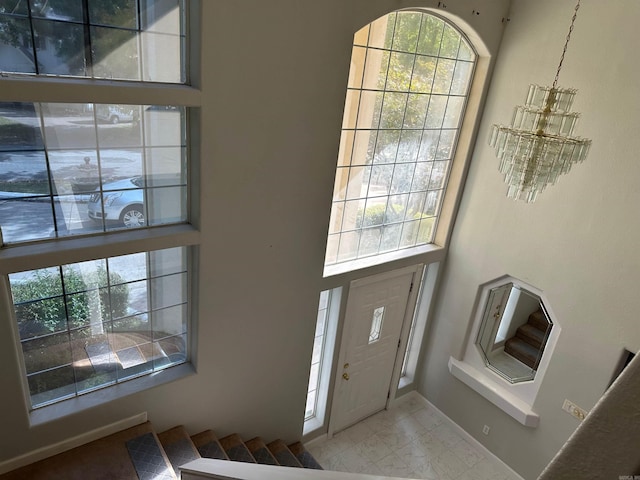 entrance foyer featuring a notable chandelier