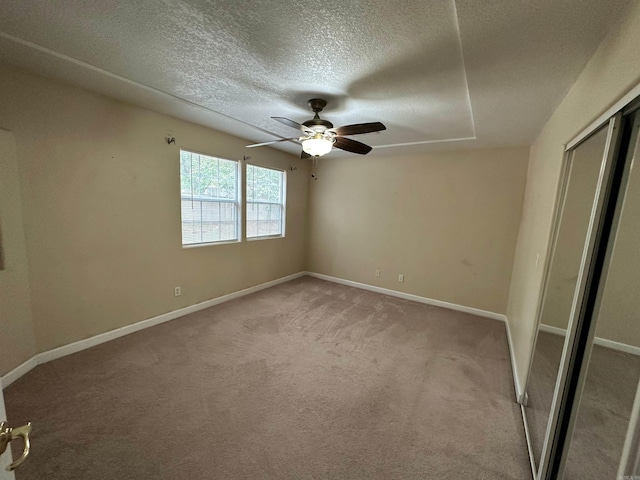 spare room with light carpet, a textured ceiling, and ceiling fan