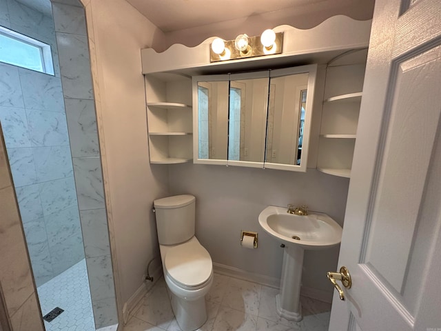 bathroom with toilet and tiled shower