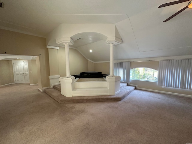 bonus room with light carpet, decorative columns, vaulted ceiling, and ceiling fan