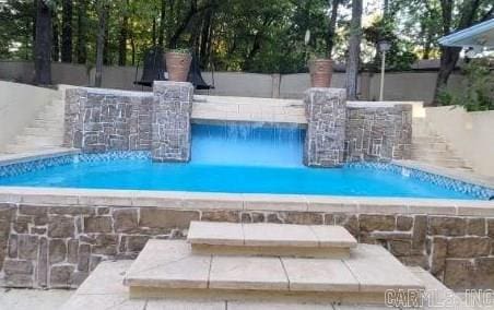 view of pool with pool water feature