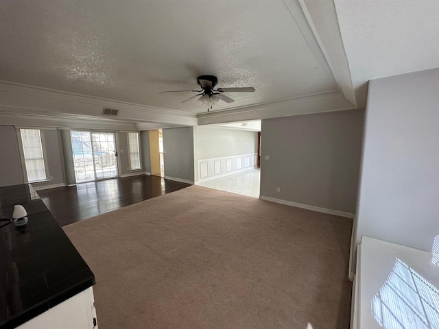 unfurnished room with a textured ceiling, crown molding, wood-type flooring, and ceiling fan