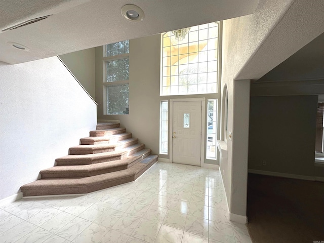 entryway featuring a healthy amount of sunlight and a textured ceiling