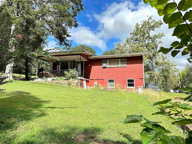 back of house with a lawn