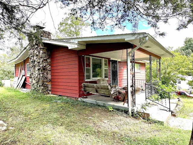 exterior space with a lawn and a porch