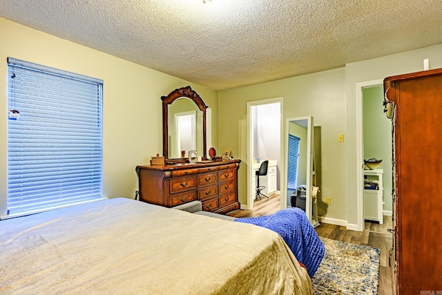 bedroom featuring a textured ceiling and light wood-type flooring