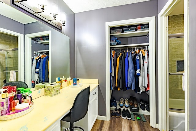 bathroom featuring vanity, an enclosed shower, hardwood / wood-style floors, and a textured ceiling