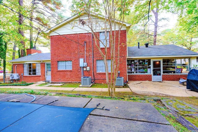 rear view of house with a patio and central AC unit