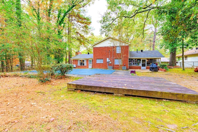 back of property with a wooden deck