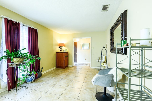 tiled foyer entrance featuring a textured ceiling